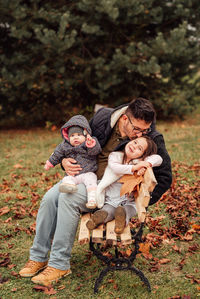 High angle view of father with daughter against autumn leaves