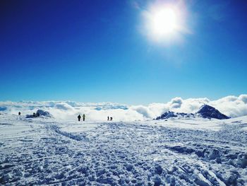 Scenic view of snow landscape against blue sky