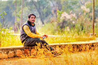 Portrait of young man sitting outdoors