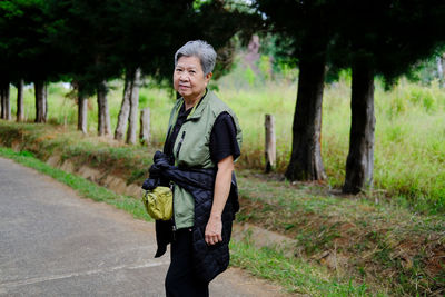 Portrait of woman standing in forest