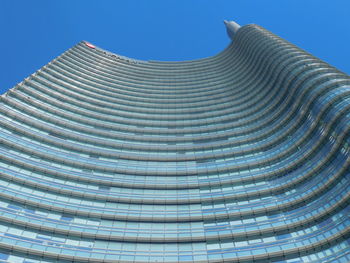 Low angle view of modern building against clear blue sky