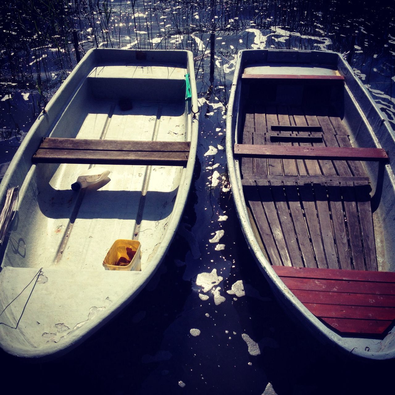 transportation, mode of transport, land vehicle, high angle view, text, car, part of, communication, close-up, nautical vessel, day, no people, boat, outdoors, cropped, western script, reflection, travel, stationary, sunlight