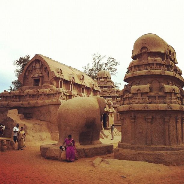 architecture, building exterior, built structure, clear sky, lifestyles, men, place of worship, person, rear view, leisure activity, religion, sitting, sky, spirituality, walking, copy space, day, history, travel destinations