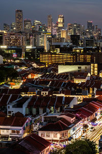 High angle view of illuminated buildings in city at night