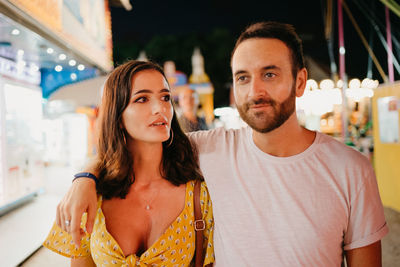 Couple walking on street at night