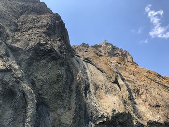 Low angle view of rock formation against sky