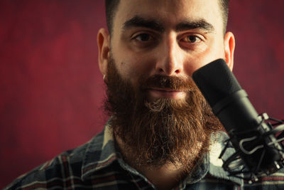 Portrait of young man looking away while standing outdoors