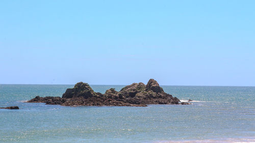 Scenic view of calm sea against clear sky