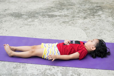 High angle view of girl lying on floor