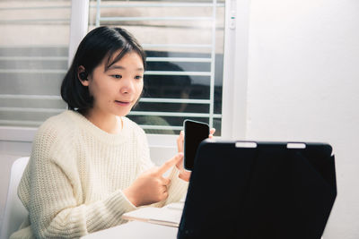 Young woman using smart phone