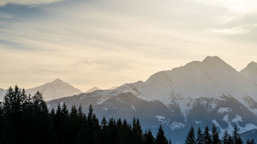 Scenic view of snowcapped mountains against sky during sunset