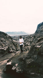 Rear view of man walking on mountain