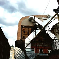 Low angle view of building against cloudy sky