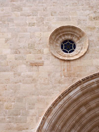 Low angle view of cross on wall