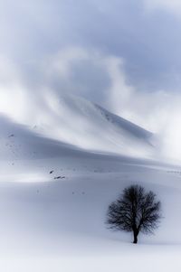 Scenic view of snow covered landscape against sky