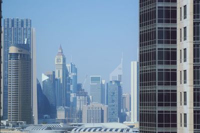 Modern buildings in city against clear sky