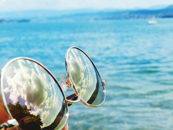 Close-up of sunglasses on beach