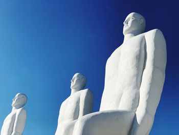 Low angle view of statue against blue sky