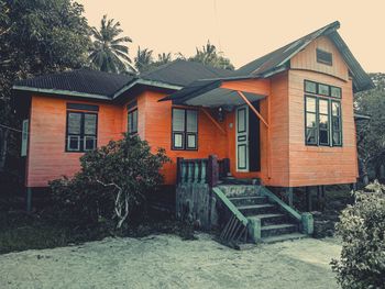 Exterior of house by building against sky