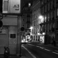 Illuminated street in city