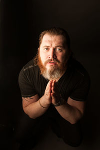 Portrait of a man against black background