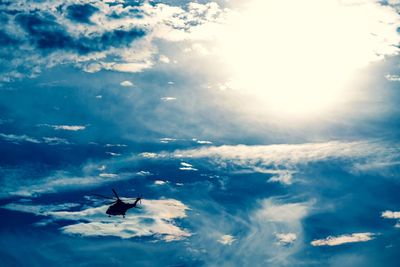 Low angle view of silhouette airplane flying in sky