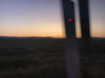 Scenic view of silhouette land against sky at sunset