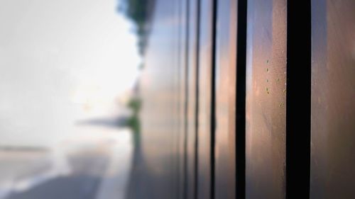 Close-up of glass window against sky