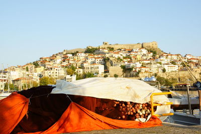 Buildings in town against clear blue sky