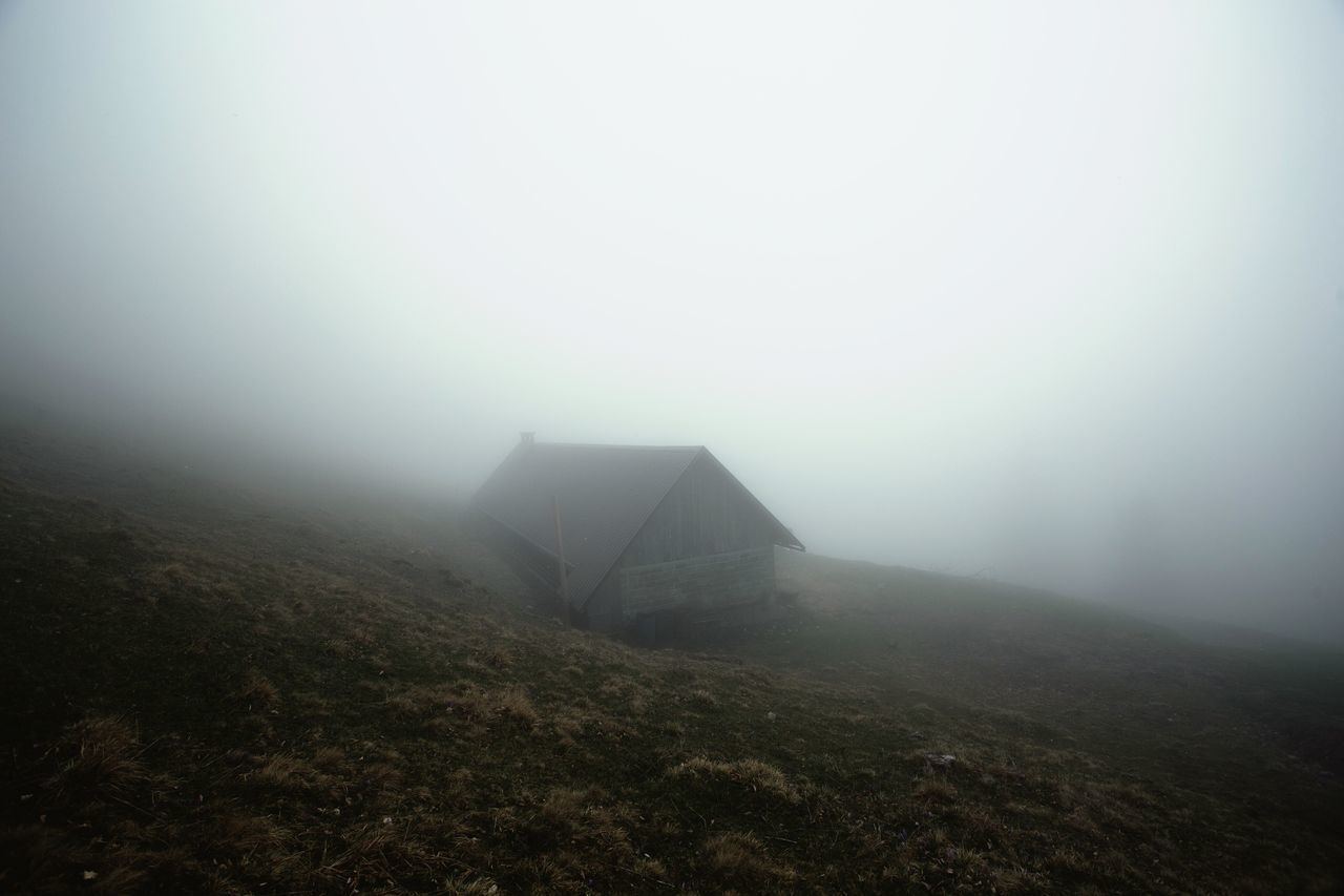 SCENIC VIEW OF FOGGY WEATHER AGAINST SKY