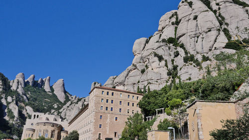 Low angle view of buildings against blue sky