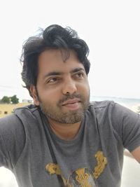 Portrait of young woman against white background