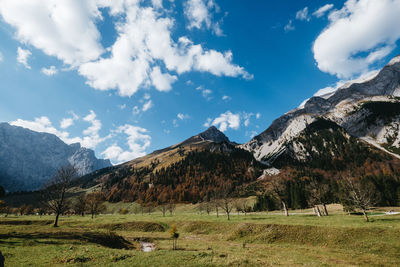 Scenic view of field and mountains against sky