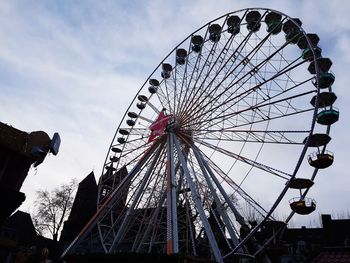 Low angle view of ferris wheel against sky