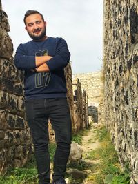 Portrait of smiling man standing against sky