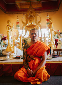 Portrait of monk sitting in temple
