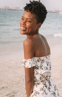 Smiling woman standing at beach