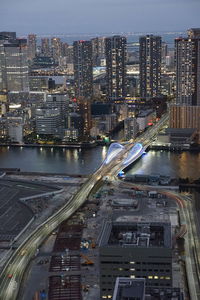 High angle view of illuminated buildings in city against sky