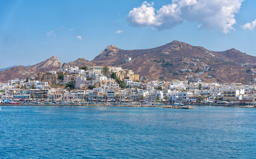 View of city by sea against sky