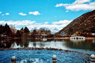 Scenic view of lake by trees against sky