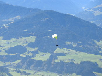 High angle view of hot air balloon flying over mountains