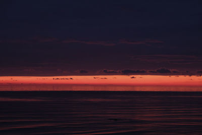 Scenic view of sea against romantic sky at sunset