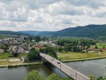 High angle view of river amidst trees against sky