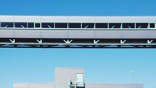 Low angle view of office building against blue sky