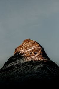 Low angle view of rock formations against sky