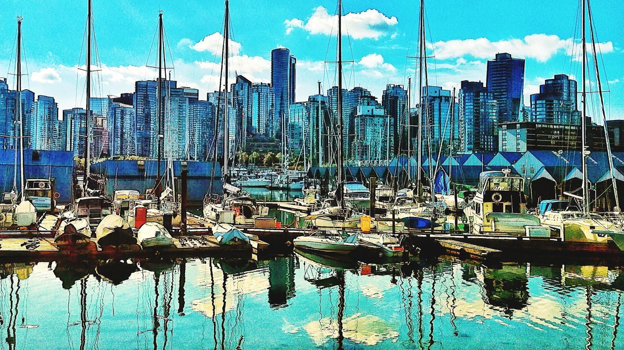 marina, water, cityscape, sky, nautical vessel, architecture, dock, building exterior, built structure, reflection, transportation, moored, city, building, mode of transportation, nature, no people, day, office building exterior, skyline, harbor, skyscraper, cloud, vehicle, waterfront, sailboat, travel destinations, boat, travel, outdoors, urban area, landscape, metropolis, pole, sunlight, urban skyline, ship, sea, blue, mast, yacht