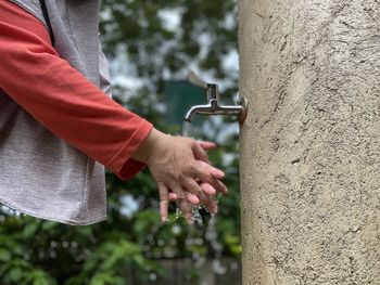 Close-up of washing hands with sink