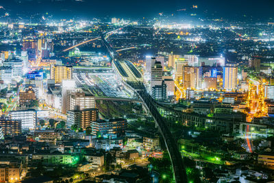 High angle view of illuminated buildings in city at night