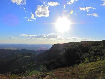 Scenic view of mountains against sky on sunny day