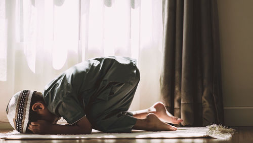 Side view of man working on table